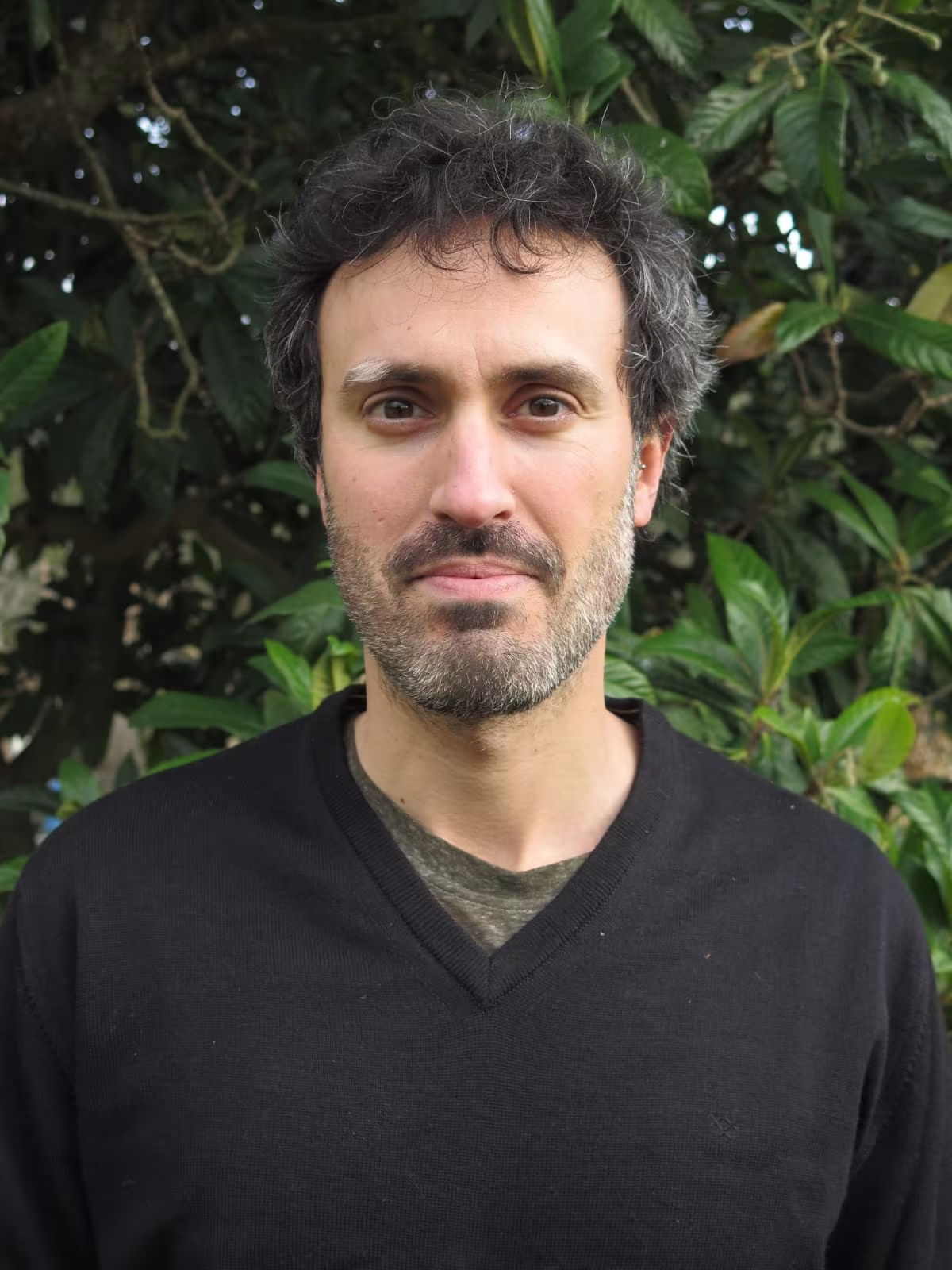 Marc Aixalà, psychologist and Holotropic Breathwork facilitator, in front of green foliage