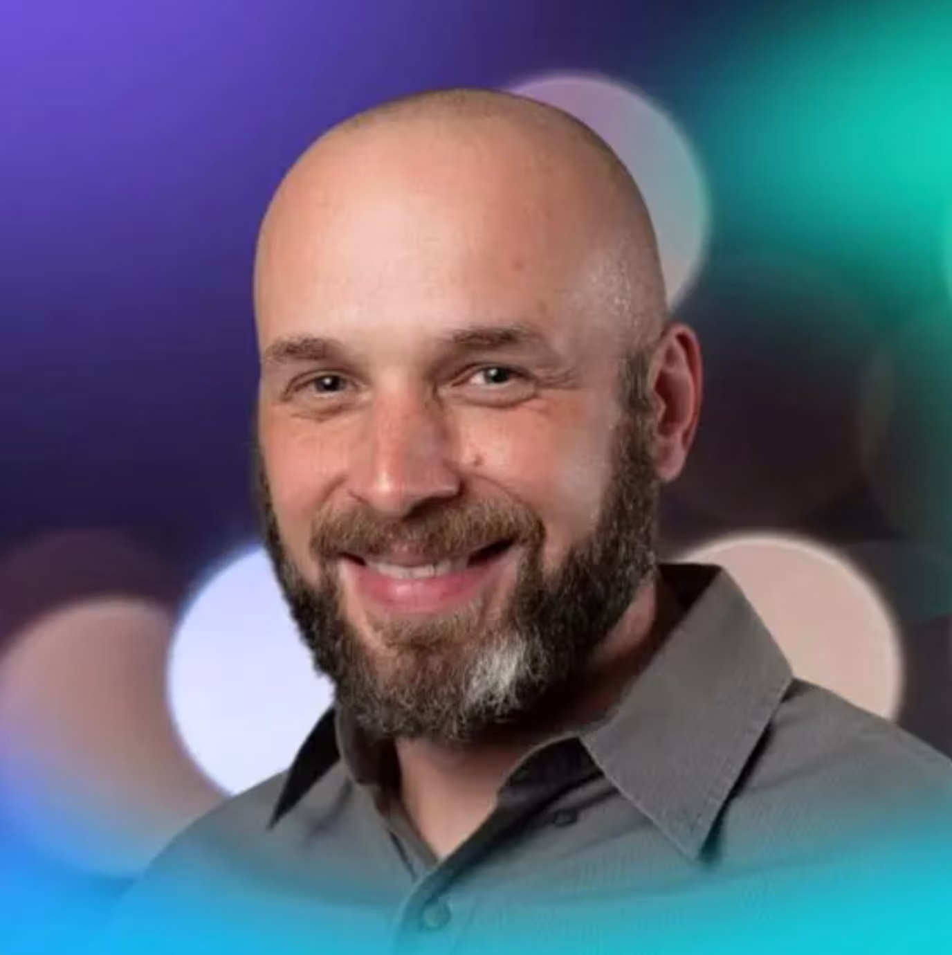 Geoff Bathje smiling against a background of blurred lights