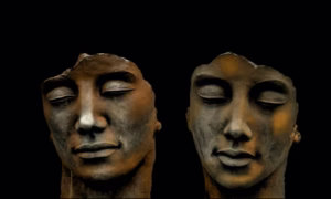 Dos rostros esculpidos con los ojos cerrados sobre fondo negro